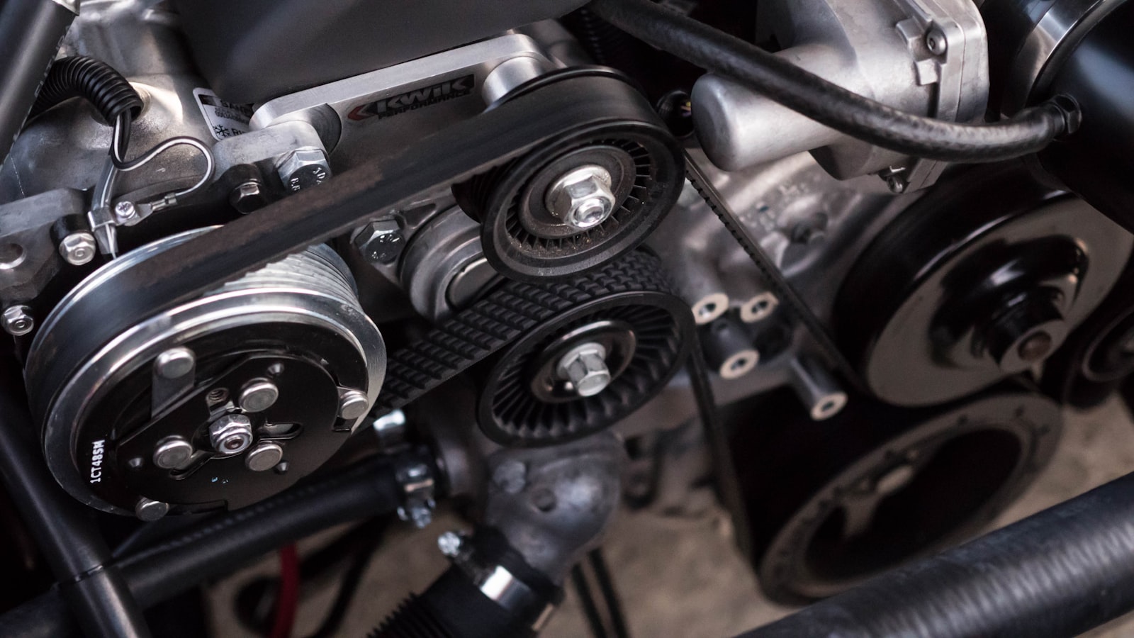 Detailed view of a modified engine bay with performance intake piping